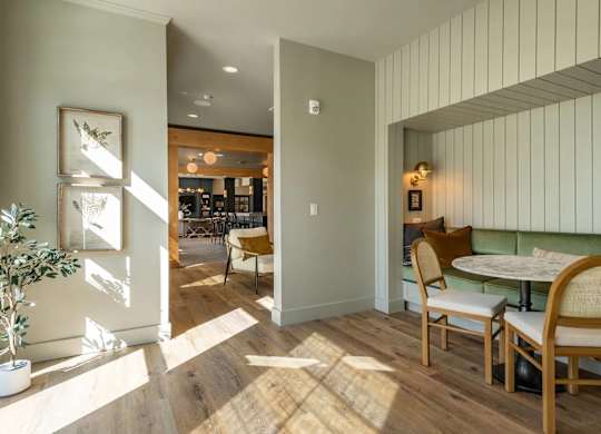 A dining area with a table and chairs.