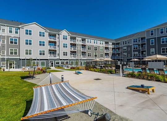 A large building with a pool and a slide in front.