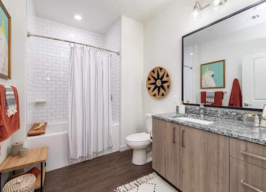 A bathroom with a toilet, sink, and shower.