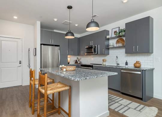 A kitchen with a white door and a wooden chair.