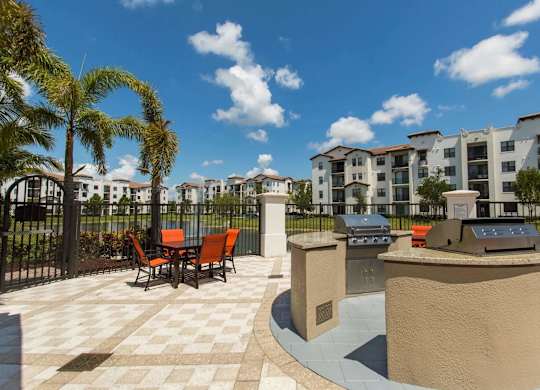 A sunny day at a resort with a palm tree and a building in the background.