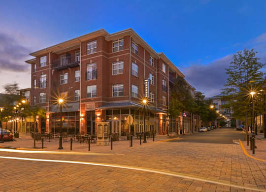 A large red brick building with a balcony on the second floor.