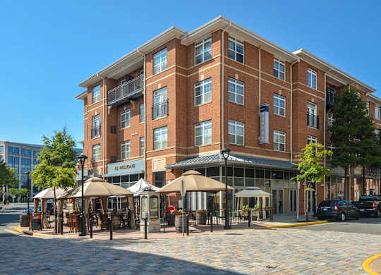 A large brick building with a cafe in front.