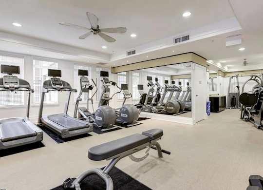 A spacious home gym with a variety of exercise equipment.