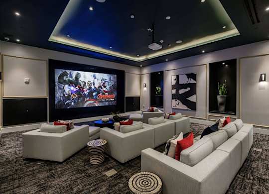 A modern home theater with a large screen and comfortable seating.
