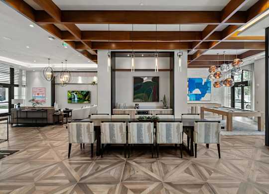 A modern dining room with a large table and chairs.