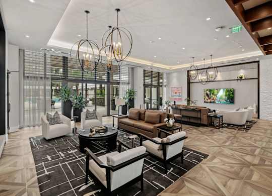 A modern living room with a black and white patterned rug and a variety of seating options.