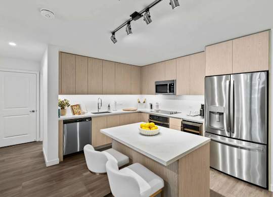 A modern kitchen with a white table and chairs.