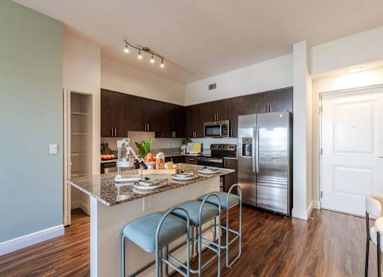 A kitchen with a counter and a refrigerator.