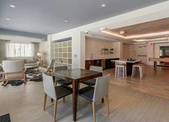 A modern dining room with a wooden table and chairs.