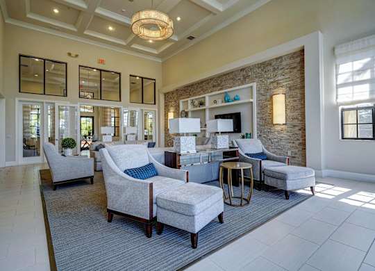 A living room with a grey rug and a white sofa.