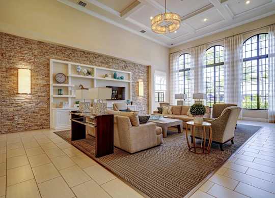 A living room with a brick wall and a large window.