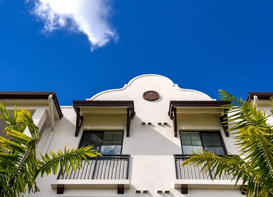 A white building with a balcony and a balcony railing.