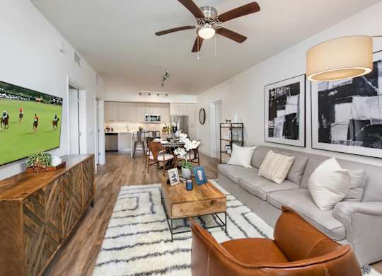 A living room with a grey couch and a wooden coffee table.