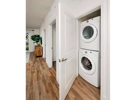 A white washing machine is in a doorway.