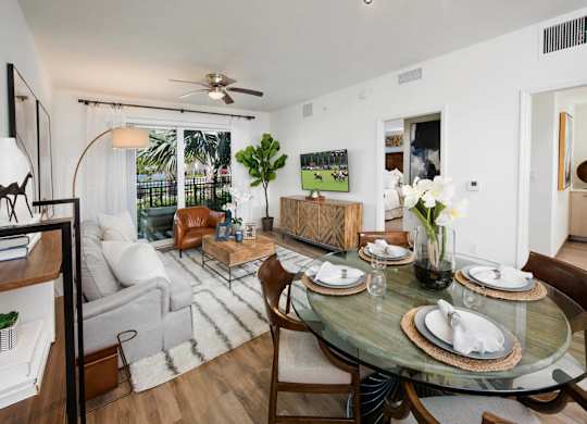 A dining room with a glass table and chairs.