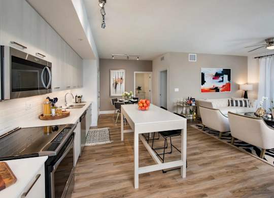 A modern kitchen with a dining table and chairs.