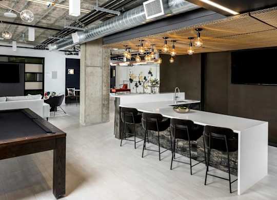 A modern kitchen with a pool table.