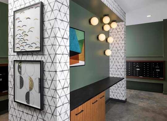 A hallway with a black counter and a wall with a picture of birds on it.
