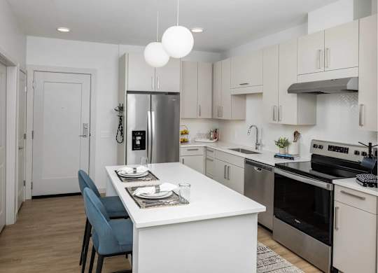 A modern kitchen with a dining table and chairs.