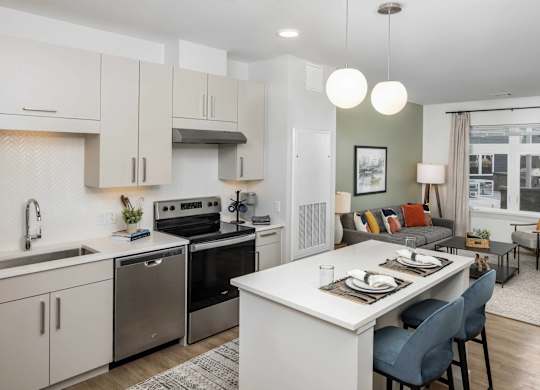 A modern kitchen with a dining area.