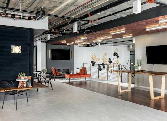 A modern room with a long table and chairs.