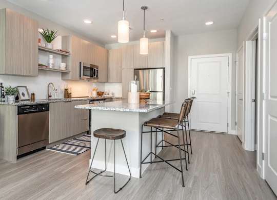 A modern kitchen with a bar stool and a countertop.