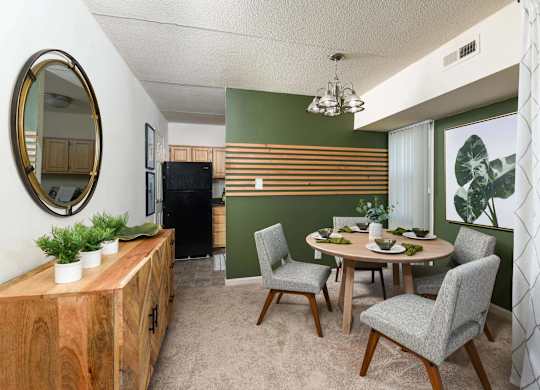 A dining room with a wooden table and chairs.