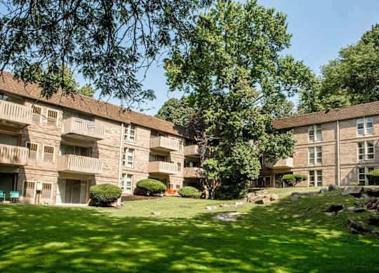 A grassy area in front of apartment buildings.