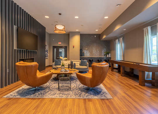 A modern living room with a striped wall and two yellow chairs.