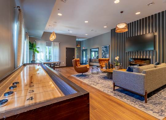 A billiard table is in the middle of a well-furnished room.