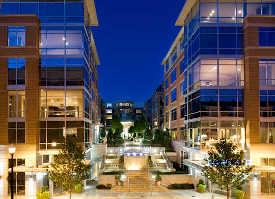 A modern building with glass windows and a courtyard in the center.
