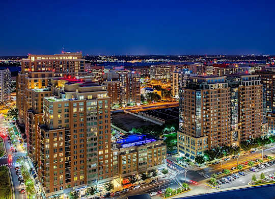 A cityscape at night with buildings and lights.