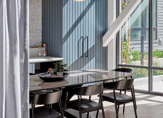 A modern dining room with a table set for two.