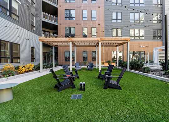 A patio with a table and chairs is surrounded by buildings.