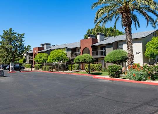 A street view of a residential area with houses and parked cars at Reflections at Red Mountain Apartments, Mesa 85213
