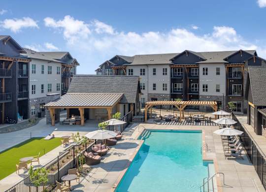 A large building with a pool in front.