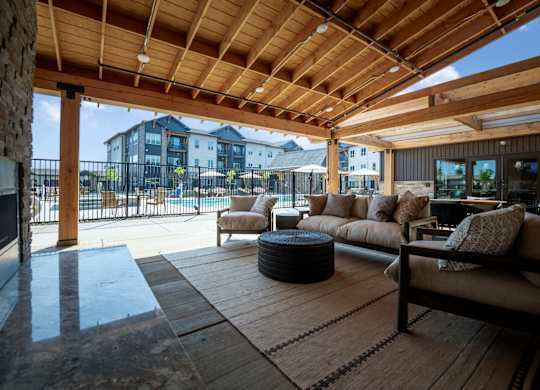 A wooden patio with a couch and a table.