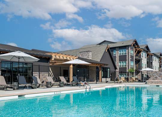 A large swimming pool in front of a resort.