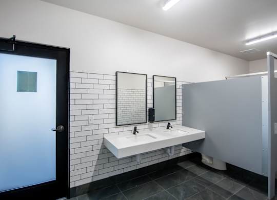 A bathroom with a white sink and a mirror above it.