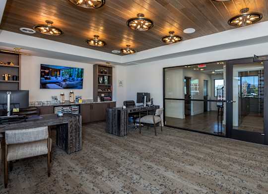 A room with a wooden ceiling and a television mounted on the wall.