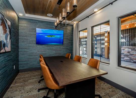 A conference room with a long table and chairs.
