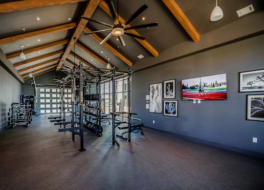 A room with a ceiling fan and pictures on the wall.