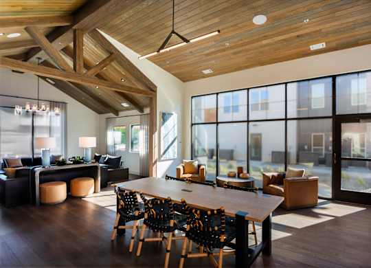 A modern dining room with a wooden table and chairs.