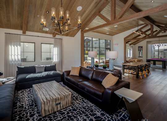 A modern living room with a dark brown leather couch and a wooden coffee table.