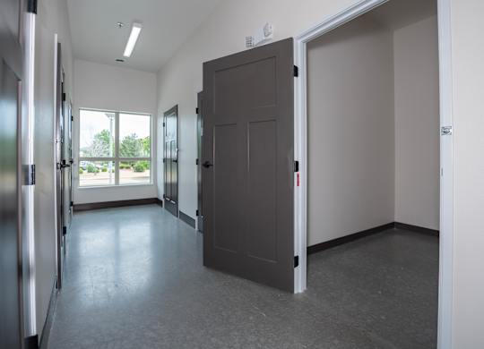 A room with a grey floor and a grey door.