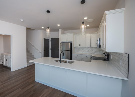 a kitchen with white cabinets and a white counter top at The Crossings  at Windsong, Prescott Valley, Arizona