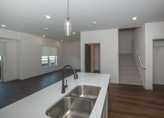 a white kitchen with a stainless steel sink and a white counter top at The Crossings  at Windsong, Prescott Valley, Arizona