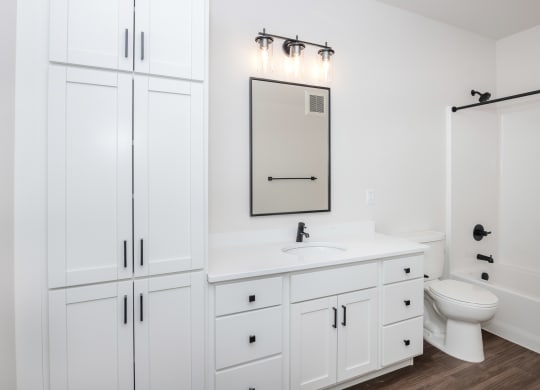 a white bathroom with white cabinets and a white toilet and sink at The Crossings  at Windsong, Arizona, 86314