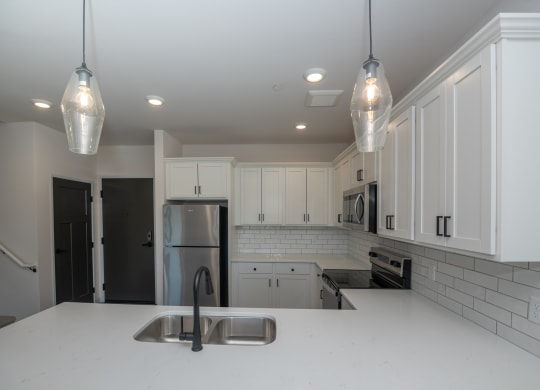 a kitchen with white cabinets and a white counter top at The Crossings  at Windsong, Prescott Valley